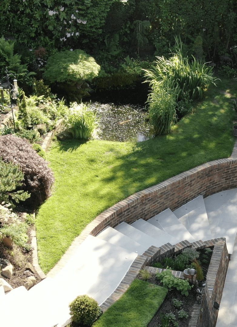 Pond in large sloped garden