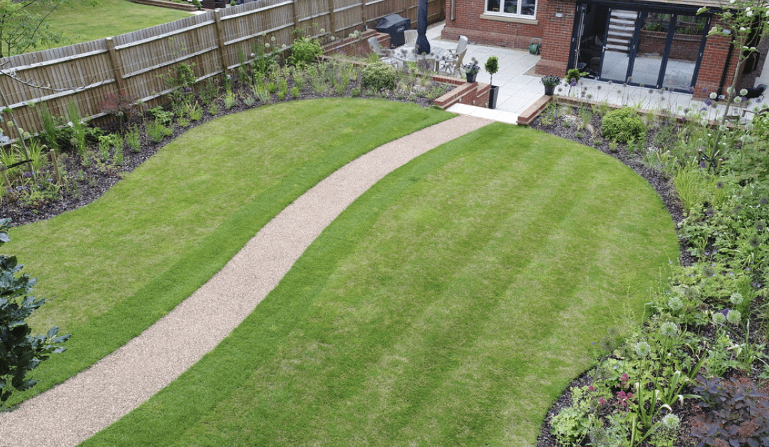 Resin pathway through lawn and planting landscape garden design Reigate