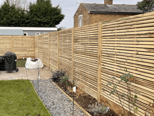 Pressure treated slatted fencing in Esher slatted fencing